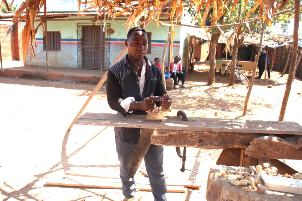 Thokozani Banda working at his carpentry workshop in Chitedze Trading Centre, Lilongwe, where he makes furniture after completing the Tingathe Vocational Training Program.